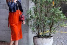 a black tee, a cropped navy leather jacket, an orange midi velvet skirt and vintage-inspired shoes