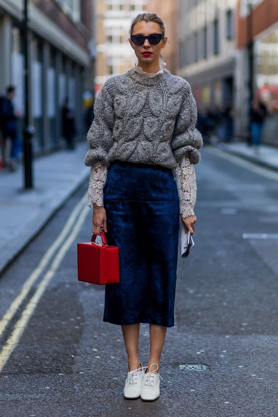a navy velvet midi skirt, a grey sweater over a lace shirt, white sneakers and a red bag