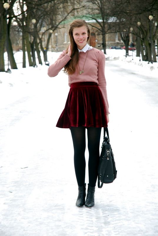 a pink sweater, a white shirt, a red velvet mini skirt, black tights and black booties