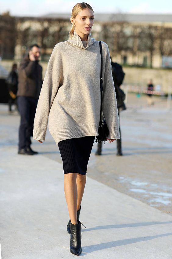 black leather booties, a black pencil skirt and a neutral oversized sweater
