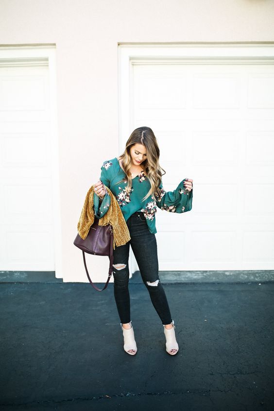 black ripped jeans, an emerald floral shirt, a mustard cardigan and neutral peep toe booties