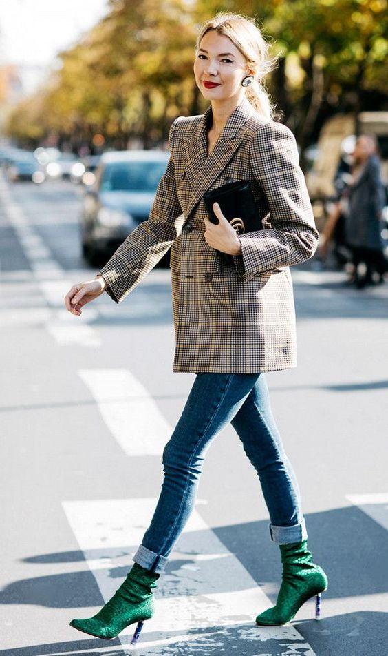 blue cuffed jeans, a tweed coat and bold emerald sock boots to stand out