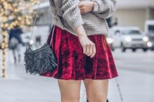 16 pair a red velvet mini skirt with an oversized neutral sweater and suede boots
