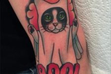 Cat in ghost costume tattoo on the arm