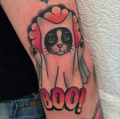 Cat in ghost costume tattoo on the arm