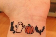 Cute tiny ghost, cat, pumpkin and bat tattoos on the wrist