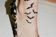Elegant black bats tattoo on the ankle and foot