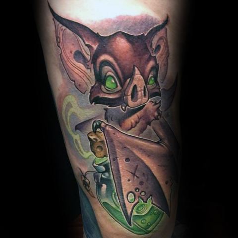 Green eyed goblin tattoo