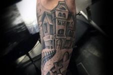 Haunted house and coffin tattoo on the forearm