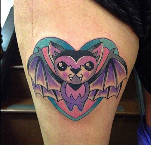 Pink and purple cartoon bat tattoo on the leg