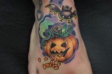 Pumpkin and bat tattoo on the foot