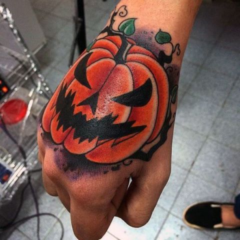 Scary pumpkin tattoo on the hand
