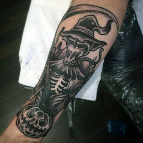 Skeleton in hat and pumpkin tattoo on the hand