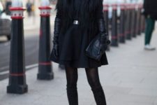With black fur mini coat, high suede boots and clutch