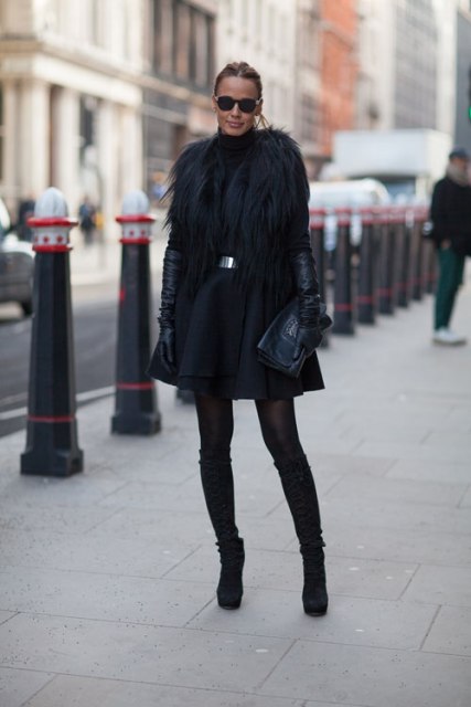 With black fur mini coat, high suede boots and clutch