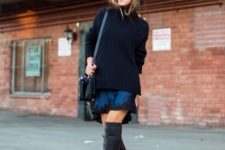 With black oversized sweater, lace dress and leather bag