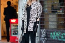 With black shirt, black pants, two color shoes, printed coat and bag