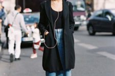 With black top, black coat and boots