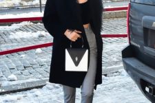 With black top, gray cuffed trousers, flat boots, fur coat and two color bag