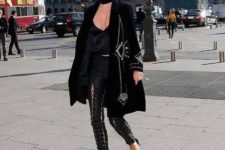 With black top, heels and embellished coat