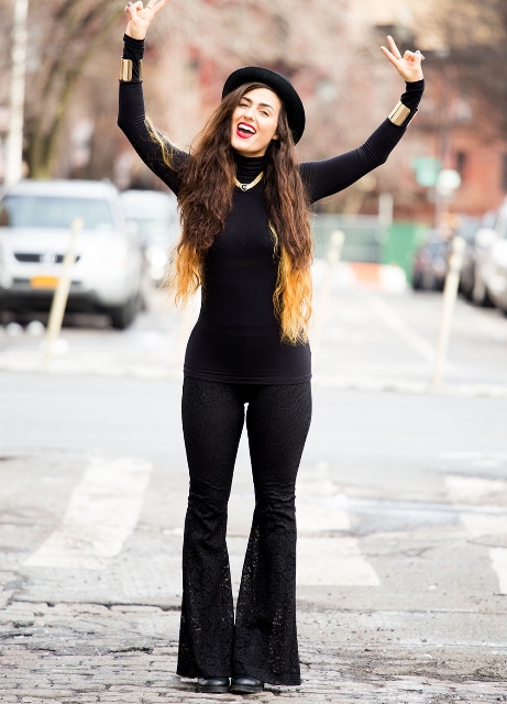 With black turtleneck, flare pants and boots