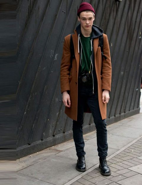 With brown coat, black pants and boots