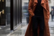 With burnt orange maxi coat, black pants and boots