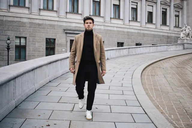 With camel coat, black pants and white shoes