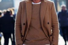 With camel coat, sweater, white t-shirt and brown pants