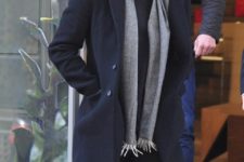 With gray scarf, navy blue coat and jeans