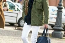 With green jacket, white pants, blue tote and black boots
