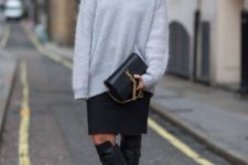 With knee-length skirt, gray loose sweater and clutch
