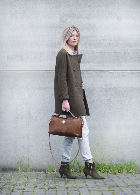 With light blue shirt, white pants, brown suede bag and olive green coat