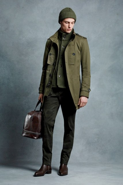 With olive green cardigan, trousers, brown shoes and big brown bag