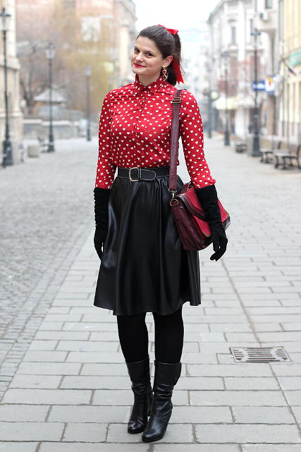 With printed blouse, leather skirt, red bag and black boots