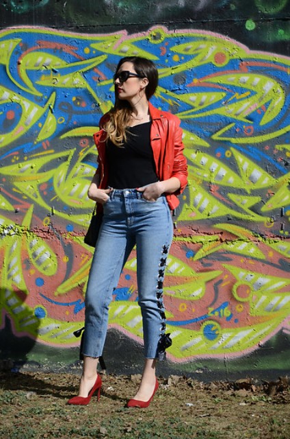 With red leather jacket, black top and red pumps