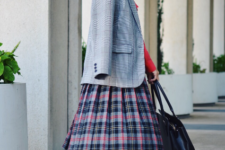 With red shirt, plaid midi skirt, flat shoes and bag