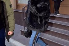 With short fur coat, velvet boots and leather bag