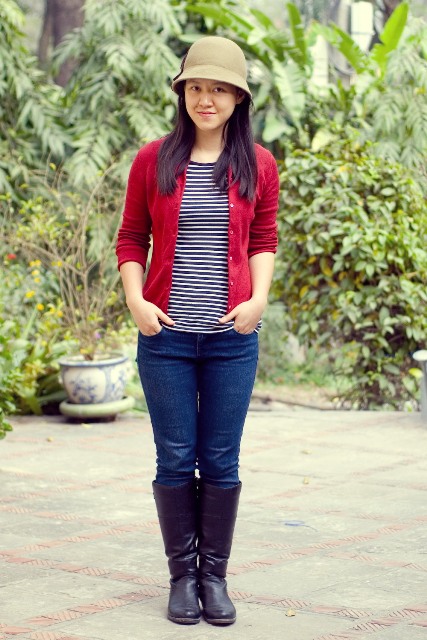 With striped shirt, red jacket, jeans and high boots