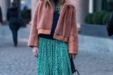With striped sweater, printed maxi skirt, flat boots and clutch