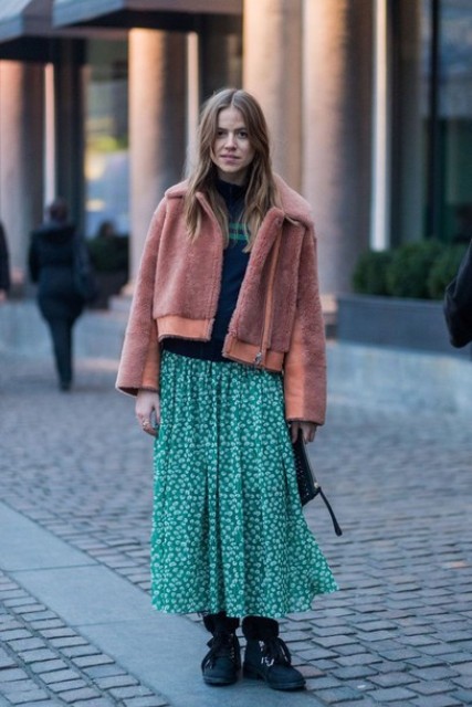 With striped sweater, printed maxi skirt, flat boots and clutch