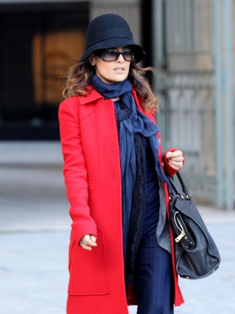 With striped trousers, blue scarf, red coat and black leather bag