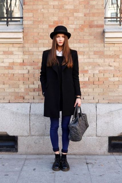 With sweater, jeans, black boots and gray bag
