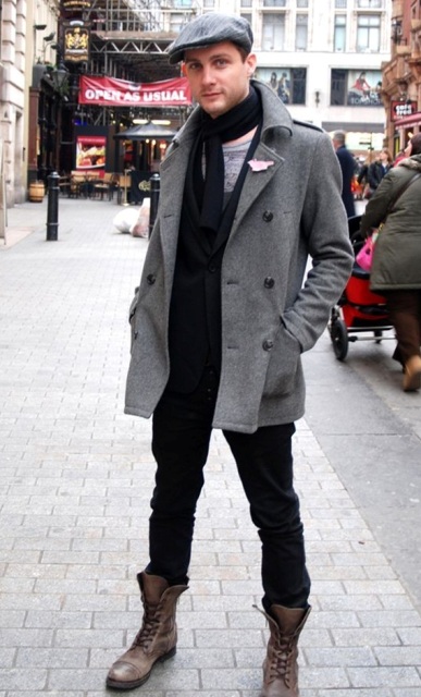 With tweed coat, black scarf, black pants and boots