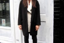 With white cardigan, black coat, skinny pants and boots