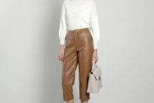 With white sweater, beige ankle boots and beige bag