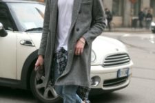 With white t-shirt, cuffed jeans, gray coat and black shoes