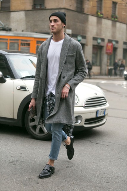 With white t shirt, cuffed jeans, gray coat and black shoes