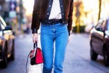 With white turtleneck, crop jeans, white ankle boots and black and red bag