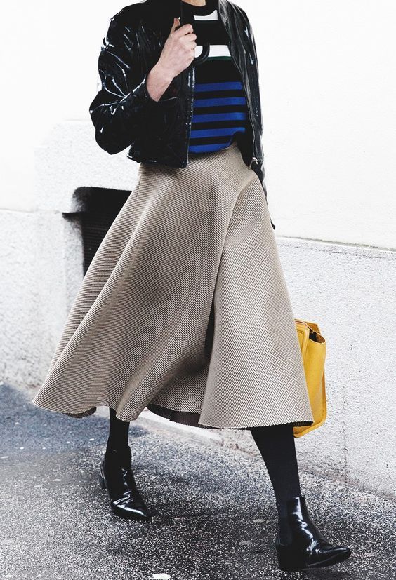 a striped sweater, a black cropped leather jacket, a wooden midi skirt and chelsea boots